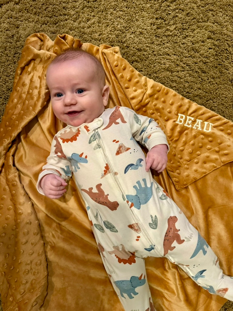 Little Beau is too small to have a cigar, so he'll settle for an embroidered blanket!